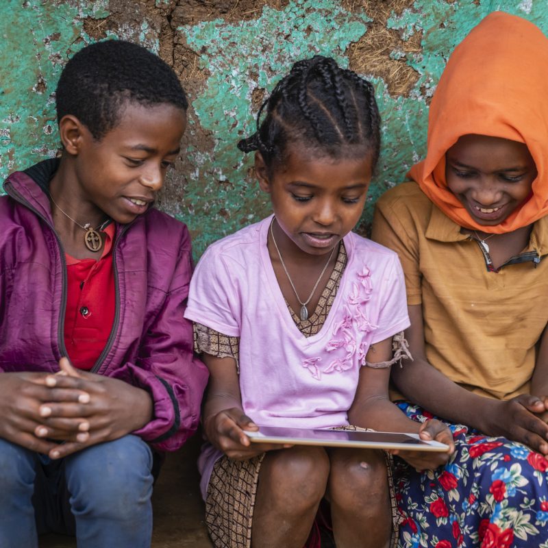 African children using digital tablet, East Africa African children using digital tablet in the village in Central Ethiopia, Africa.